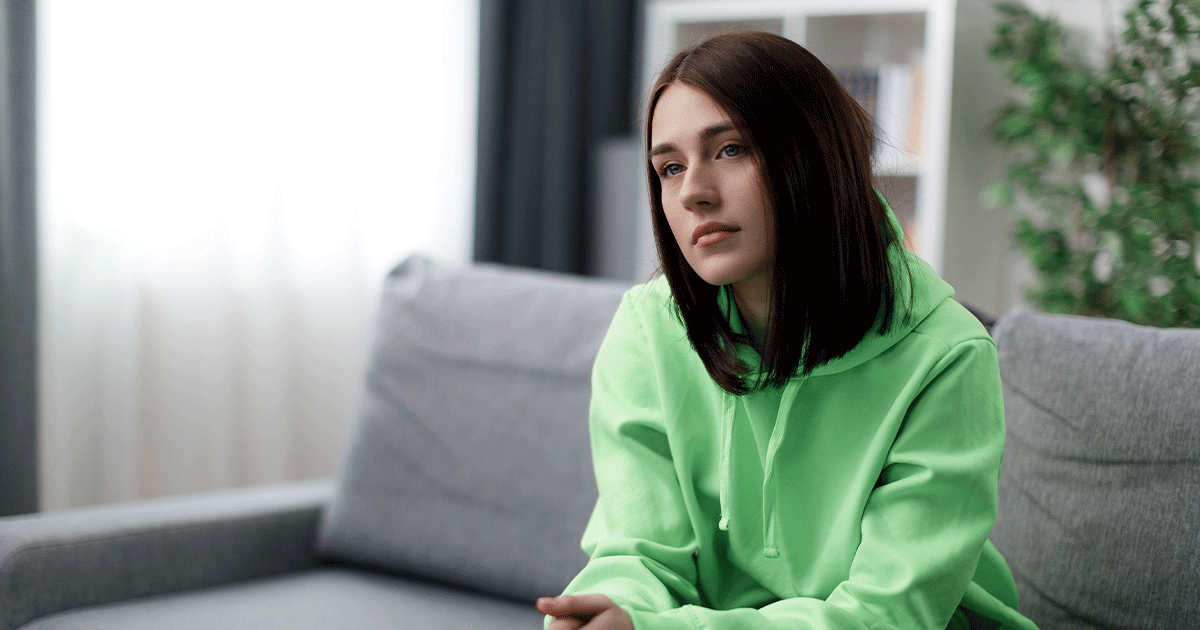 Thoughtful woman considering the difference between blood and urine pregnancy tests.
